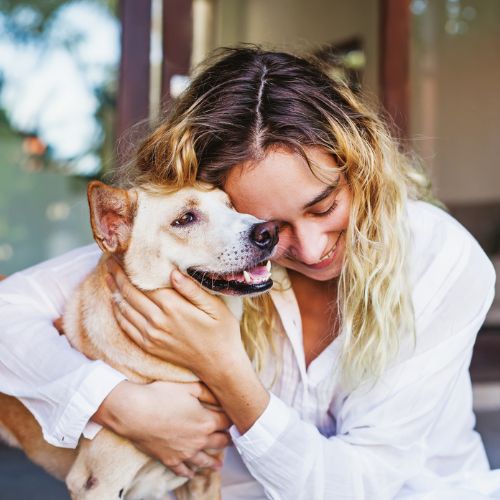 Woman embracing a dog